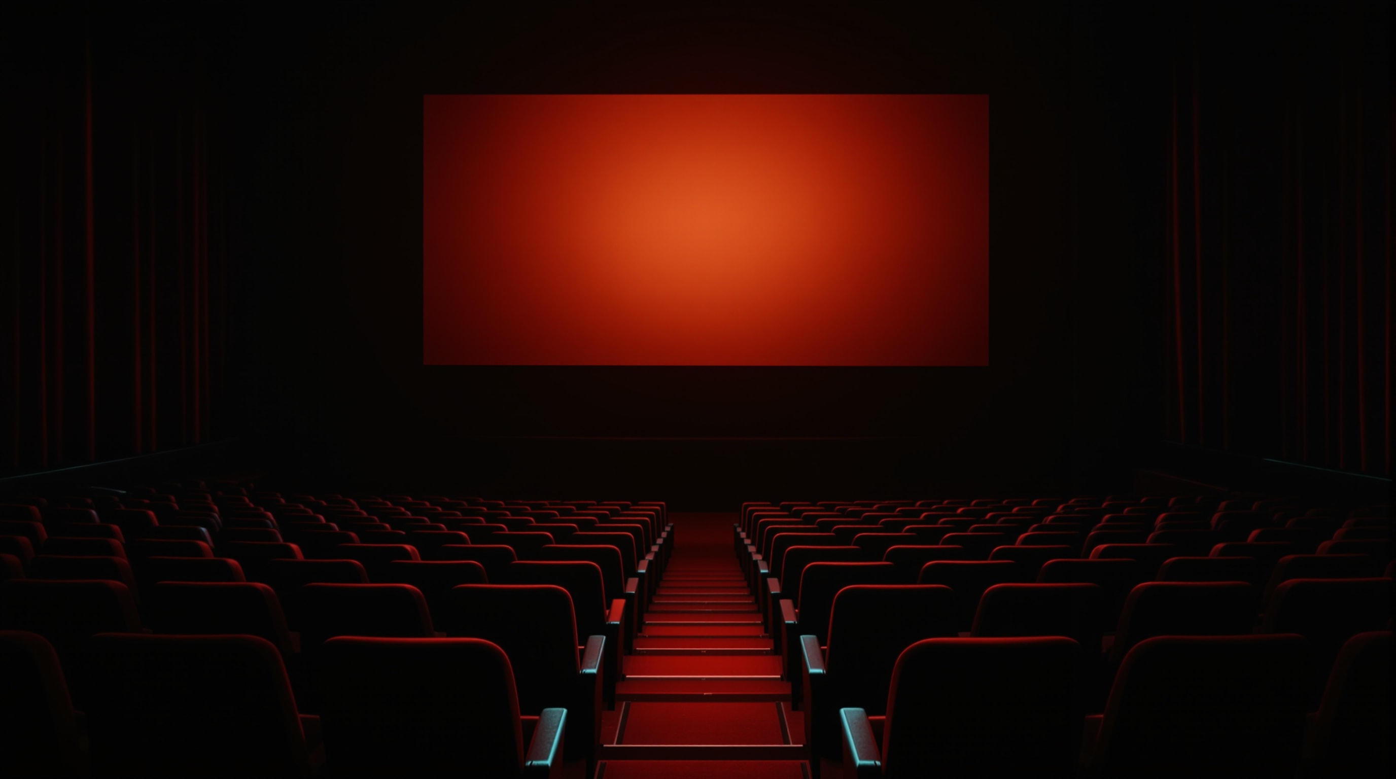 Rows of empty red-tinted cinema seats fading into shadow beneath a glowing blank screen